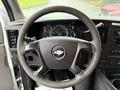 Steering wheel and dashboard of a 2009 Chevrolet Express showing gauges and controls