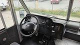 Interior view of a 2006 Ford Econoline showing the driver's seat dashboard steering wheel and control panel