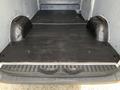 A 2017 Mercedes-Benz Sprinter with an empty cargo area featuring a black floor and wheel wells on each side