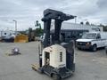 A 2004 Crown RR5210-35 forklift with a black mast and control panel is parked on a hard surface with a prominent operator seat and forks for lifting.