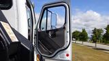 A 2017 Freightliner M2 106 truck with its driver's side door open showcasing the interior and panel details