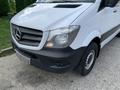 A 2017 Mercedes-Benz Sprinter van with a white exterior and a black lower front grille showing its distinctive logo and headlights