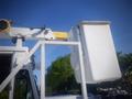 A white 2006 Freightliner FS65 bucket truck with an extended boom and bucket attachment on the side