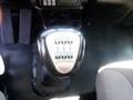 A gear shift of a 2008 Peterbilt 335 with a sleek silver handle and labeled gear positions