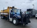 A 2016 International 7400 truck with a yellow dump bed and a black front-mounted plow attachment