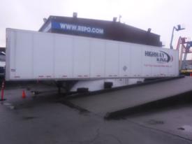 A white 2023 Wabash International trailer with "HIGHWAY KING" branding on the side positioned on a ramp