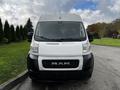 A 2019 RAM Promaster van with a white front and black grille parked on a paved surface