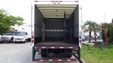 The image shows the rear view of a 2016 Hino 195 truck with an open cargo area featuring a wooden floor and a step ladder on the left side