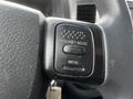 Close-up of the cruise control buttons on the steering wheel of a 2008 Dodge Ram 5500 featuring buttons for resume and accelerate along with a deceleration button