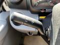 A close-up of the turn signal and headlight control stalk of a 2020 Hino 195 truck showcasing its features and markings