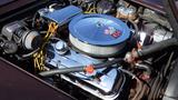 Close-up of a 1971 Chevrolet Corvette Stingray engine showcasing a polished chrome air cleaner and valve covers with various hoses and wiring visible