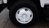 A white wheel of a 2008 Chevrolet C7500 with multiple lug nut holes and a black Goodyear tire