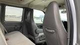 Interior view of a 2017 Chevrolet Express Quigley 4x4 focusing on the front seats and dashboard area