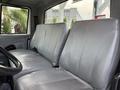 Interior view of a 2007 International 4200 featuring two gray leather seats facing forward