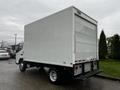 A white 2012 Mitsubishi Fuso FE box truck with a plain exterior and no visible markings or logos