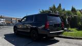 A black 2018 Chevrolet Tahoe parked at an angle showing its sleek design and tinted windows