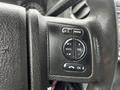 Close-up of the steering wheel controls for media and volume on a 2014 Ford F-550