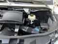 A 2022 Mercedes-Benz Sprinter with its hood open revealing the engine compartment including various engine components and fluids