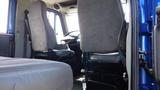 Interior of a 2012 International DuraStar 4300 showing two cloth-covered seats and a dashboard with controls in a cabin setting