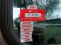 A red and white vehicle inspection sticker attached to the window of a 2007 Morgan Olson Workhorse W42 displaying approval information and a list of months