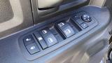 Close-up of a control panel for a 2014 RAM 3500 with buttons for power windows and door locks