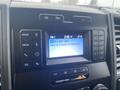 Interior view of a 2021 Ford F-550 dashboard with a digital display showing radio station and song information