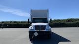 A 2019 International 4300 truck seen from the front with its doors open and a blank sign on the front bumper