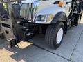 A 2007 International 7300 truck featuring a chrome grille and large tires with a visible front suspension system and front-mounted equipment