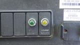 A 2011 Ford Econoline dashboard featuring two buttons one green labeled 'ON' and one silver labeled 'HYBRID SERVICE'