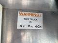 A warning sign indicating the height of a 2006 Workhorse W42 truck stating it is 9 feet 9 inches high