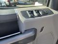 Interior detail of a 2019 Ford F-350 SD showing the driver's door controls including window switches and mirror adjustment knob
