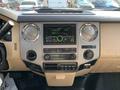 Dashboard of a 2013 Ford F-450 SD featuring a digital display radio and controls for climate and media functions