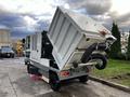 A 2007 Tennant Sentinel street cleaning machine with a raised hopper and vacuum hose attached, designed for cleaning streets and outdoor areas