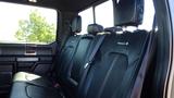 Black leather back seats of a 2017 Ford F-350 SD with headrests and seat belts visible