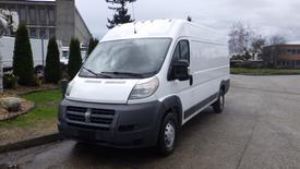 A 2016 RAM Promaster van with a white exterior and a gray front bumper parked at an angle with the driver's side facing forward