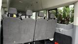 A row of grey seats in the interior of a 2017 Ford Transit van with a focus on the backrest area