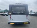 A 2017 Chevrolet Express bus viewed from the rear with high-mounted lights and a license plate at the bottom