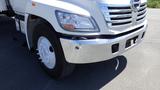 A white 2009 Hino 268 truck with a shiny chrome front bumper and visible wheel details