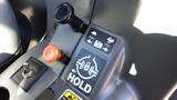 Control panel of a 2013 Kubota RTV 1100 featuring levers buttons and indicators for vehicle operation