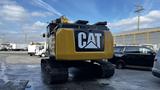 A 2018 Cat 326F Track excavator with a yellow and black exterior facing away from the viewer showcasing its logo on the rear