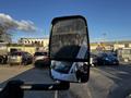 A side mirror of a 2017 Chevrolet Express reflecting part of the vehicle and surrounding cars