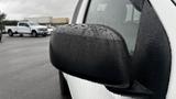 Close-up of the side mirror of a 2016 Nissan Frontier covered in raindrops