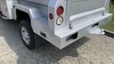 A silver 2013 RAM 2500 with a modified rear bumper featuring round taillights and a hitch receiver