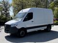 A 2022 Mercedes-Benz Sprinter van with a white exterior and black accents parked on a paved surface