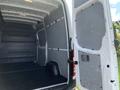 A 2017 Mercedes-Benz Sprinter van showing the open rear doors and empty cargo area with gray walls and a black floor