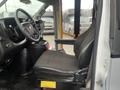 Interior view of a 2017 Chevrolet Express featuring a driver's seat with black fabric upholstery and a steering wheel visible in the foreground