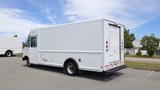 A white 2011 Ford Econoline delivery truck parked with a boxy cargo area and single rear wheels