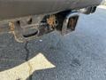 Close-up of a tow hitch receiver on a 2019 Ford F-350 SD with visible dirt and wear