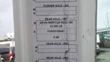 A close-up of an information sticker detailing specifications for a 2007 Autocar WXLL truck including axle types and weight limits