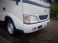 A 2003 Toyota Toyoace with a white exterior featuring a prominent grille and headlights positioned at the front